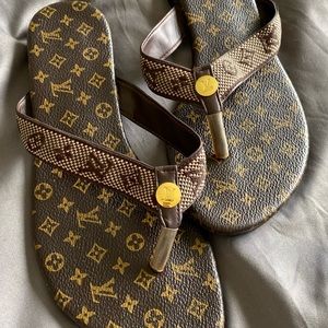 Louis Vuitton flip flops.